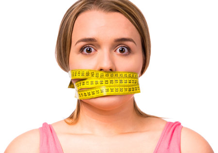 Fat woman unhappy with her body, the diet, the body measures the isolated white background