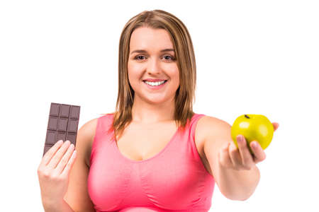 The concept of healthy eating. Fat woman dieting isolated on a white backgroundの写真素材