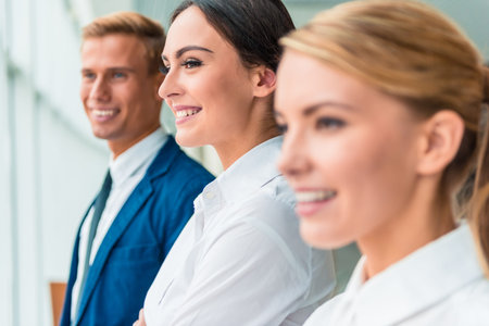 Group young business people sitting in office and holding meeting
