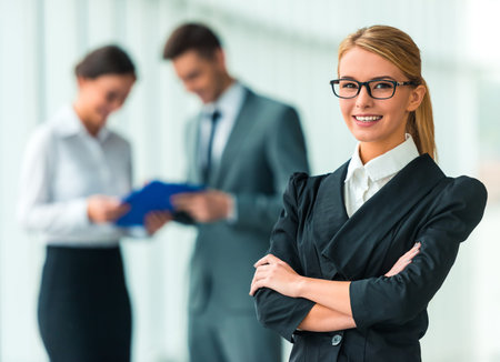 Portrait of business woman on the background of their colleagues in the office
