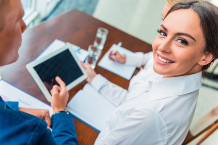 Group young business people sitting in office and holding meeting