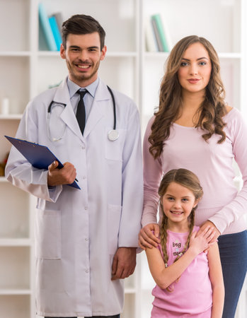 Mother and child on a review of a young doctor pediatricianの写真素材