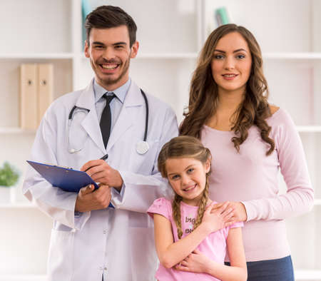 Mother and child on a review of a young doctor pediatricianの写真素材