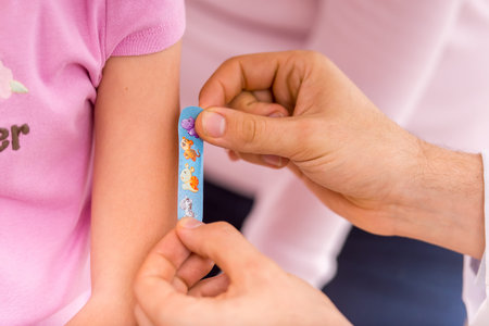 Doctor doing vaccine injection to girl in hospital
