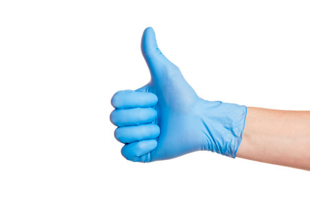 Hand of surgeon in blue medical glove showing Ok sign, isolated on a white backgroundの写真素材
