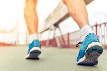 Cropped image of handsome man running, back viewの写真素材