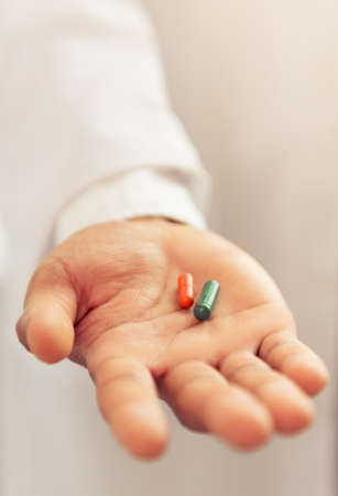 Two pills in medical doctor's palm, close-upの写真素材