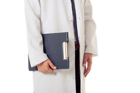 Cropped image of handsome doctor in white coat holding a folder, isolated on white background