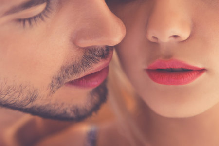 Close-up of beautiful passionate couple kissing while having intimate moment