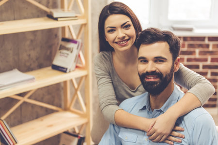 Portrait of attractive young couple looking at camera and smilingの写真素材