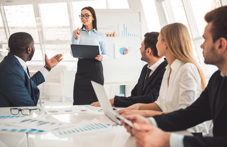 Successful business people are talking,  working with the gadgets and smiling during the conference
