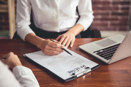 Cropped image of beautiful female employer in suit conducting a job interviewの写真素材