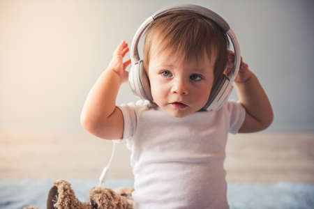 Portrait of cute baby boy with headphones smilingの写真素材