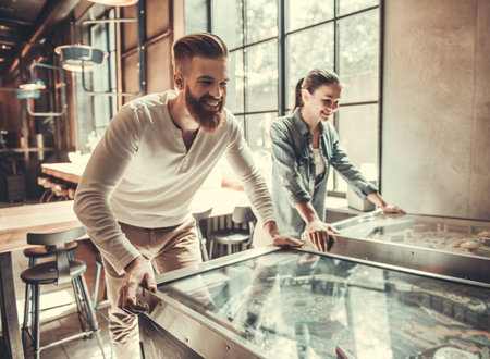 Young happy people play a board game in their office