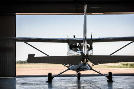Back view of a modern white aircraft in hangar waiting for passengersの写真素材
