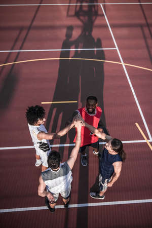 Top view of handsome basketball players playing on basketball court outdoorsの写真素材