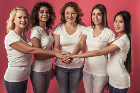 Women against breast cancer. Beautiful women of different ages and nationalities with pink ribbons...