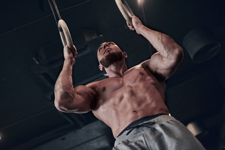 Young strong man during training in the gym