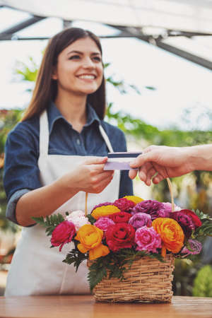 Close-up. Customer giving credit card to the seller florist.の写真素材