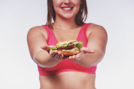 The concept of healthy eating. Fat woman dieting isolated on a white backgroundの写真素材