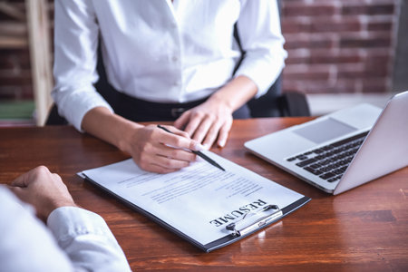 Cropped image of beautiful female employer in suit conducting a job interview
