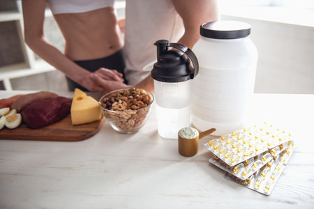 Cropped image of beautiful young sports couple cooking healthy food in kitchen at homeの写真素材