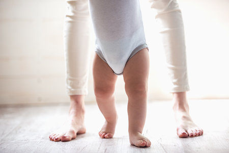 Cropped image of beautiful mom stepping with her cute babyの写真素材