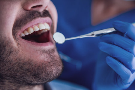 Close-up of handsome young patient visiting a dentistの写真素材