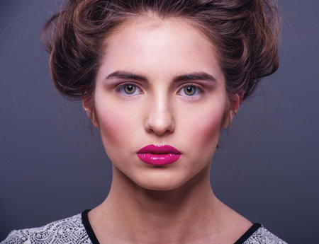Glamour Fashion Woman Portrait. Studio shooting. Gray backgroundの写真素材