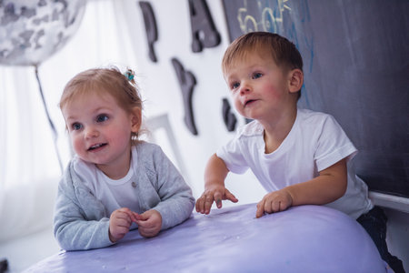 Cute stylish kids are playing in the children's roomの写真素材