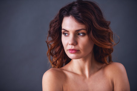 Portrait of young beautiful sexy girl on black backgroundの写真素材