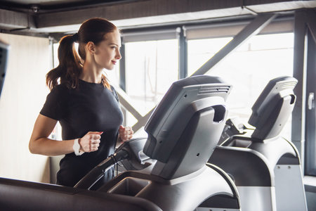 Beautiful young woman while training in the gymの写真素材