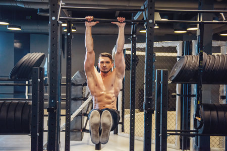 Young strong man during training in the gymの写真素材