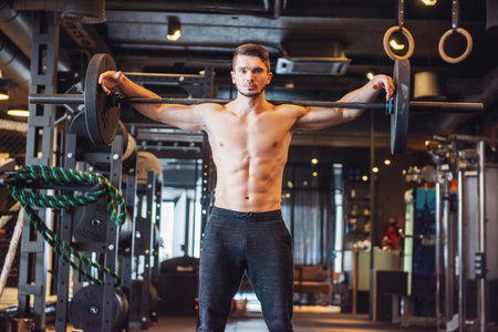 Young strong man during training in the gymの写真素材