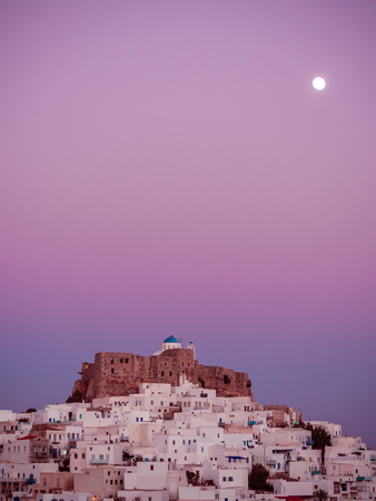 Blue hour in Astypalaia ,Greece with all the magenta colours and  the full moon above the castleの写真素材