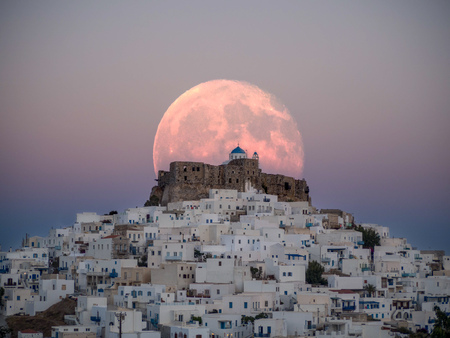 An unnatural big moon over the castle of Astypalaiaの写真素材