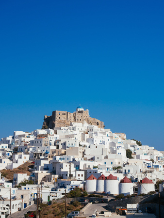 Chora of Astypapaia island ,Greece at daytime with the white houses that encircle the castle and the white windmills with the red roofs.のeditorial素材
