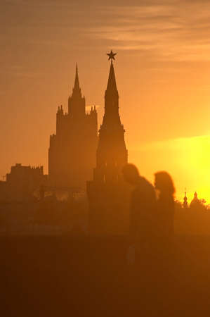 The Moscow Kremlin, a man and a women silhouettes against sunset, Moscow, Russiaの写真素材