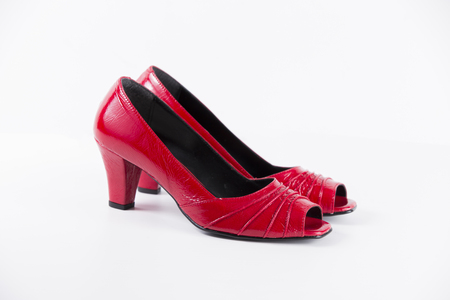 Beautiful elegance and luxury leather red shoes isolated on white backgroundの写真素材
