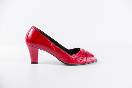 Beautiful elegance and luxury leather red shoes isolated on white backgroundの写真素材