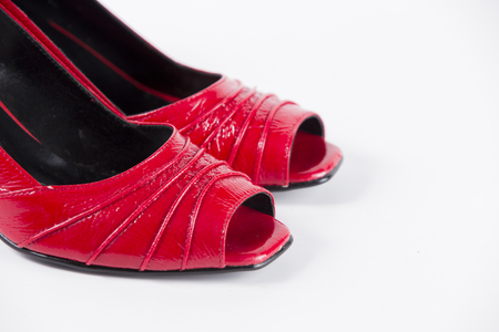 Beautiful elegance and luxury leather red shoes isolated on white backgroundの写真素材