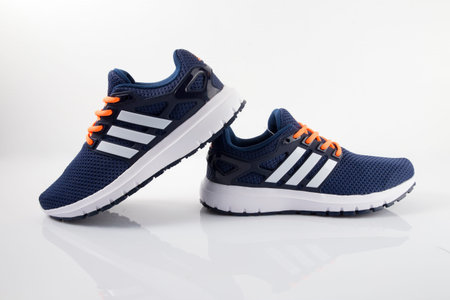 Pair of blue sneakers isolated on white background. Side view.