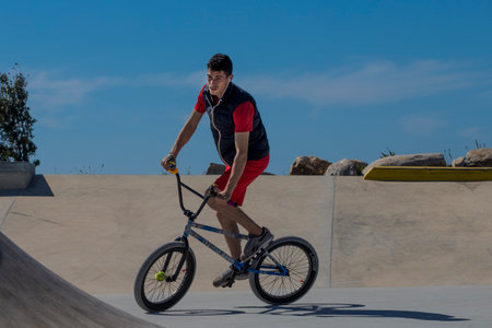 Caminha, Portugal - April 28, 2022 : Young teenager doing BMX in city park in Vila Praia de Ancora, Caminha, Portugal on April 28, 2022.のeditorial素材