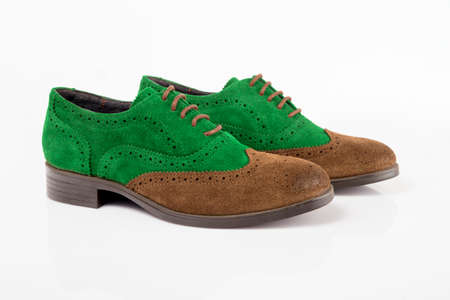 Male brown and green leather shoes on white background, isolated product.の写真素材