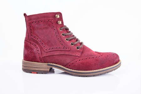 Male red leather boot on white background, isolated product. Differentiated footwear and exclusive design.の写真素材