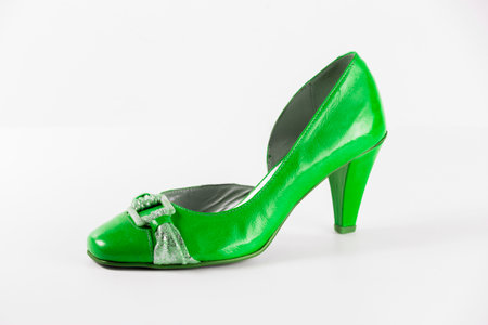 Women's sandal in bright green leather and high heels on a white background.の写真素材