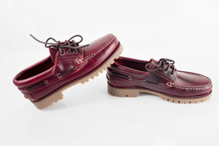 Male red leather shoes pairs on white background, isolated product.の写真素材