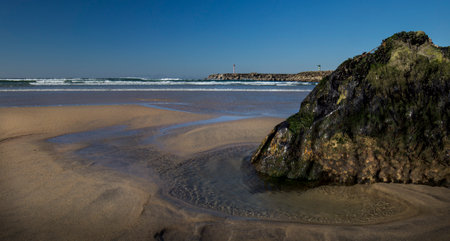 Beach in the north of Portugal with a rock in the foregroundの写真素材