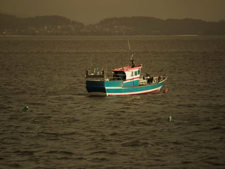 Fishing boat in the sea at sunset. Toned image.