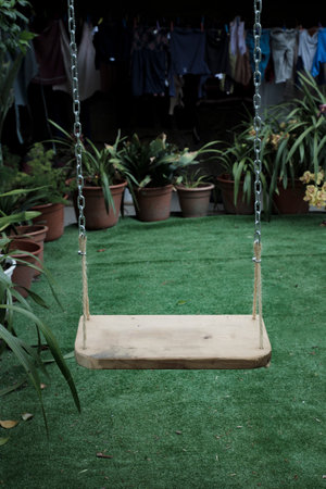 Wooden swing in the garden. Selective focus.の写真素材